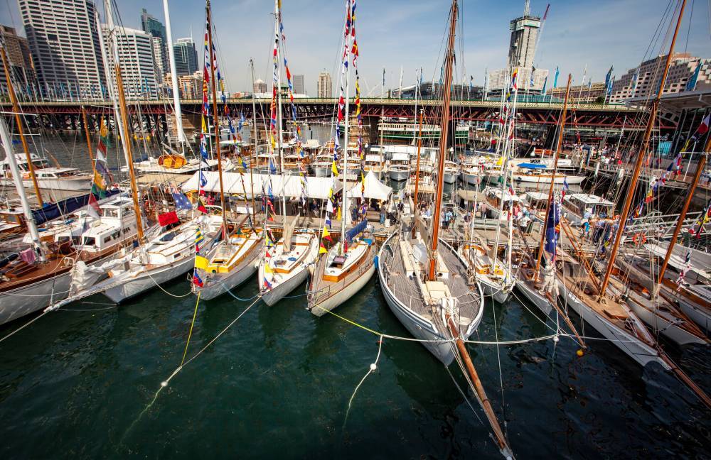 Classic Wooden Boat Festival 2016. Masted wooden boats  pictured moored together with the Pyrmont Bridge in the background.  Andrew Frolows (ANMM)