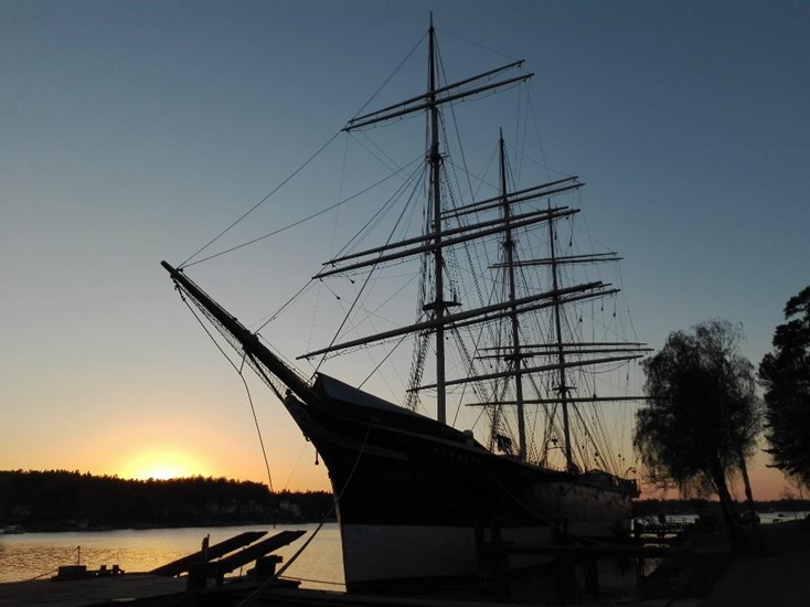 Tall-ship lying in harbour at sunset