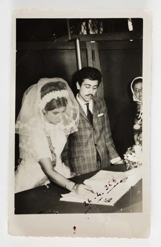 Şükran and Halit Adasal signing their marriage documents, with Şükran’s mother Sultan Salman at far right, Adana, Turkey, 1966. Reproduced courtesy Hale Adasal.