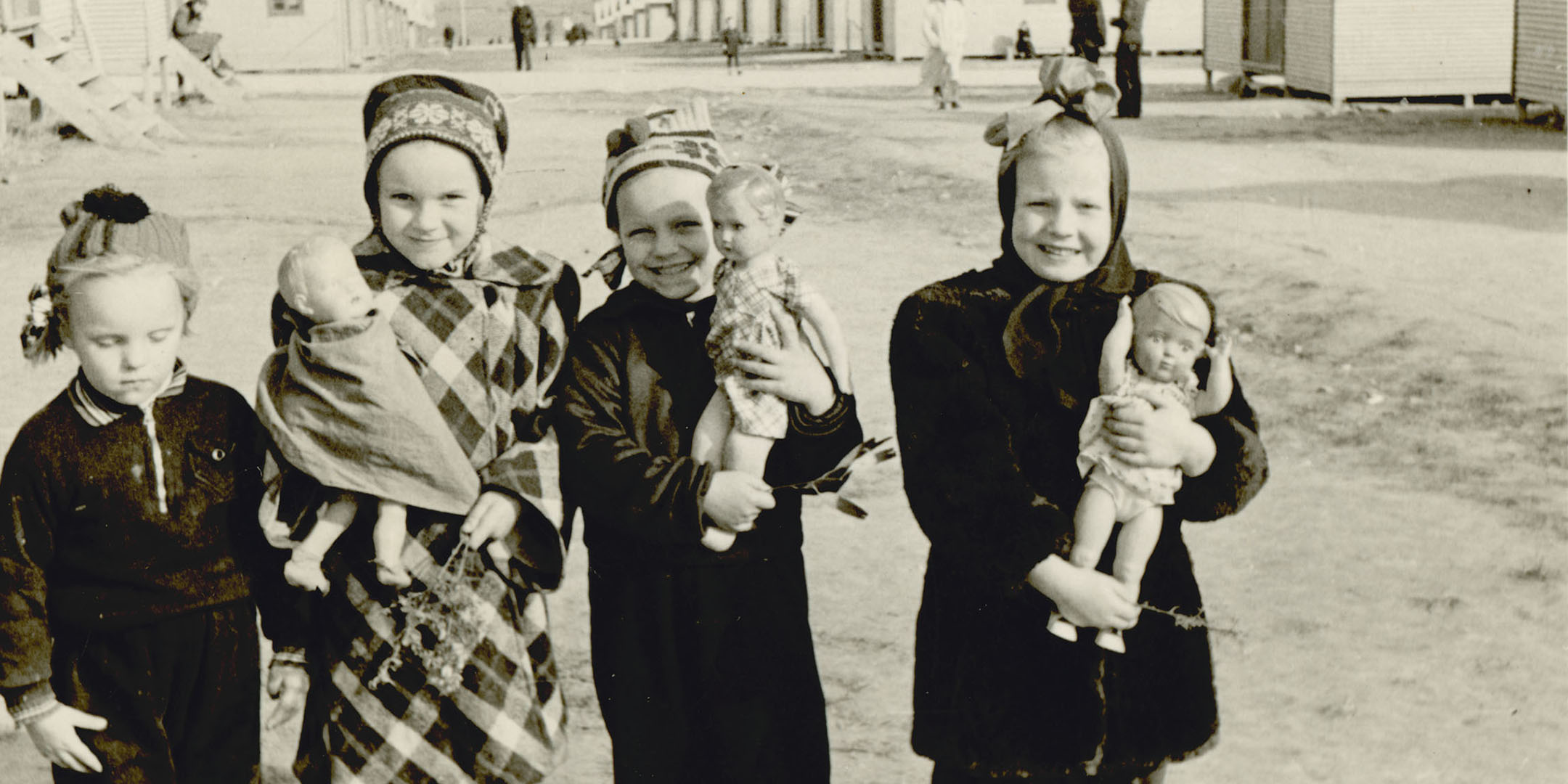 Maie Talmet (second from left) at Woodside Hostel with the doll her father gave her on arrival in Adelaide, 1949. Reproduced courtesy Maie Barrow.