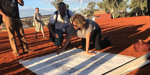 Denise Bowden, CEO of Yothu Yindi, signing the Uluru Statement from the Heart, in Central Australia, 29 May 2017, Australian Human Rights Commission.