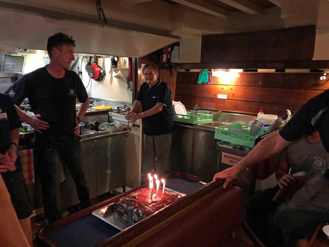 The birthday celebrations onboard begin, with the Cook. Image: Bill Ellemor. 