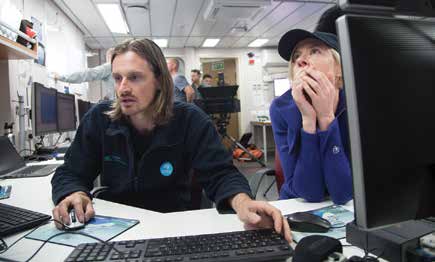 Hydrographer Matt Boyd (MNF) and Emily Jateff in the operations room on board RV Investigator during the survey of HMAS Pioneer. Image: Chris Gerbing, CSIRO/Marine National Facility.