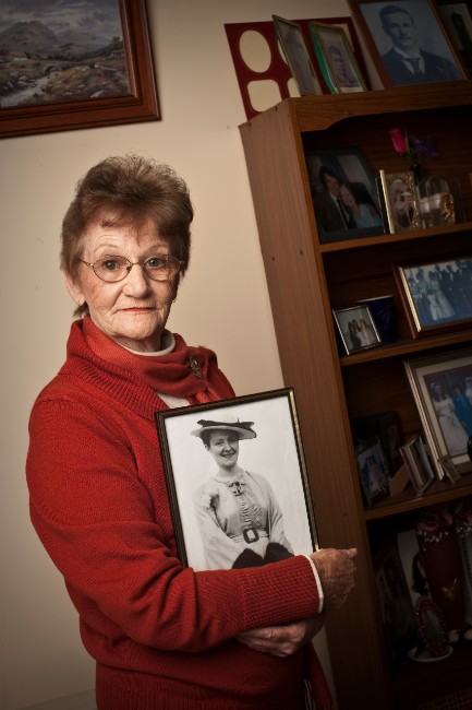 Yvonne Radzevicius with a photograph of her mother Bridget, 2010. ANMM Collection