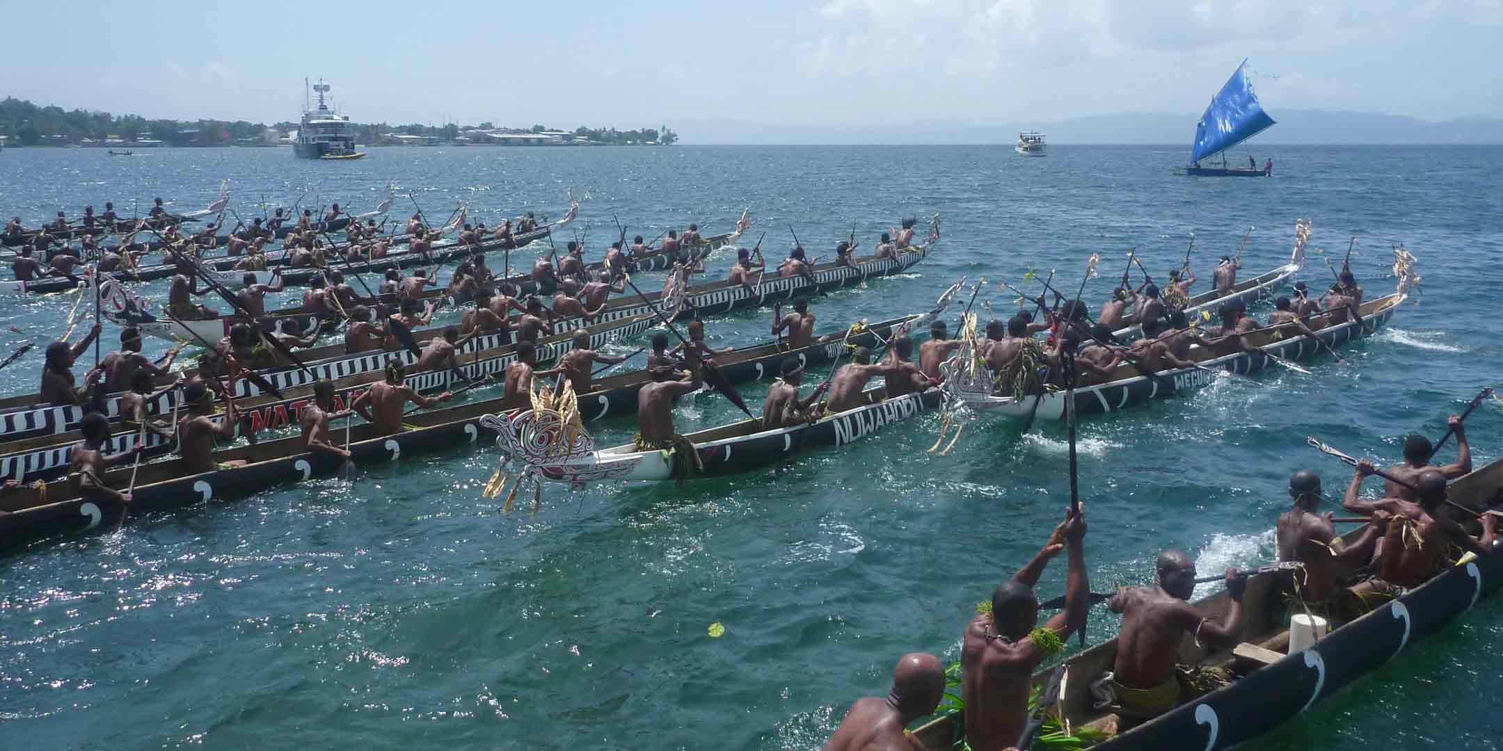 War canoes leave the beach at the K and K festival. Photo: David Payne, ANMM