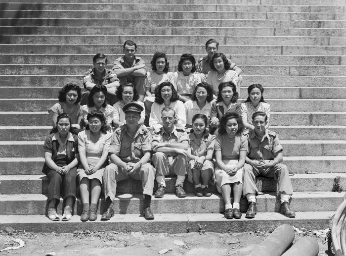 A 1946 photo showing Australian occupying forces and Japanese communication operators on the steps of the naval base at Kure. Image Australian War Memorial 