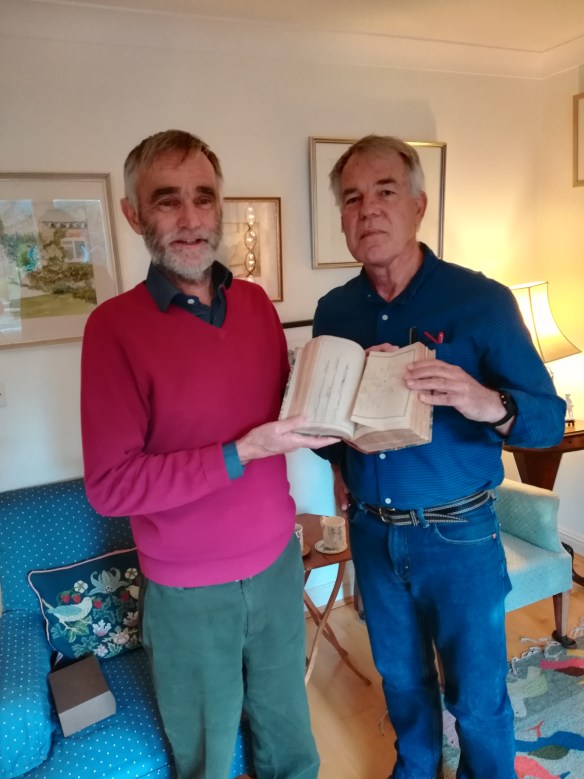 The donor of the logbook, Mr Anthony Gannon, presenting it to Dr Nigel Erskine. The book was  passed down through Mr Gannon’s maternal grandfather. Image courtesy Nigel Erskine/ANMM.
