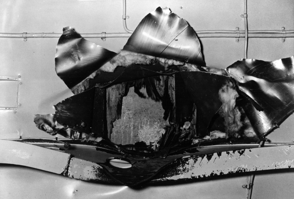 View of the underside of the flight deck structure of USS <em>Yorktown</em> showing the impact hole made by the Japanese bomb that struck the ship    during the Battle of Coral Sea, 8 May 1942. Image: Official US Navy photograph collection of the National Archives, Naval History and Heritage Command NH 95572.
