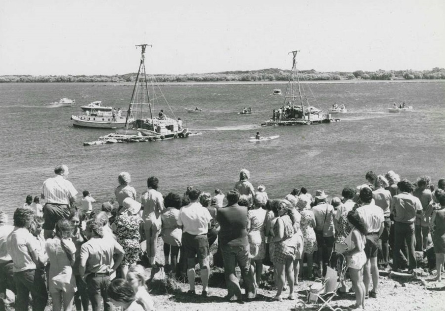 Crowds watch as two of the Las Balsas rafts make their way up the Richmond River to Ballina, New South Wales, 1973. Photograph by David Harrison. Image reproduced courtesy Ballina Naval & Maritime Museum