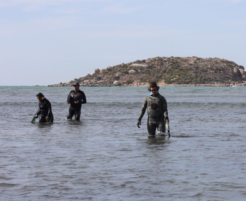 Maddy Chadrasekaran, Rick Bullers and Tim Zapor conduct a metal detector sweep within shallows just inshore of South Australian's wrecksite
