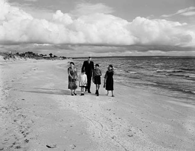 The O’Keefe family at Bonbeach, Victoria, 1956. Left to right: Annie O’Keefe, Geraldine, John O’Keefe, Peter and Mary. Photographer Neil Murray. Reproduced courtesy National Archives of Australia: A1501, A429/5.