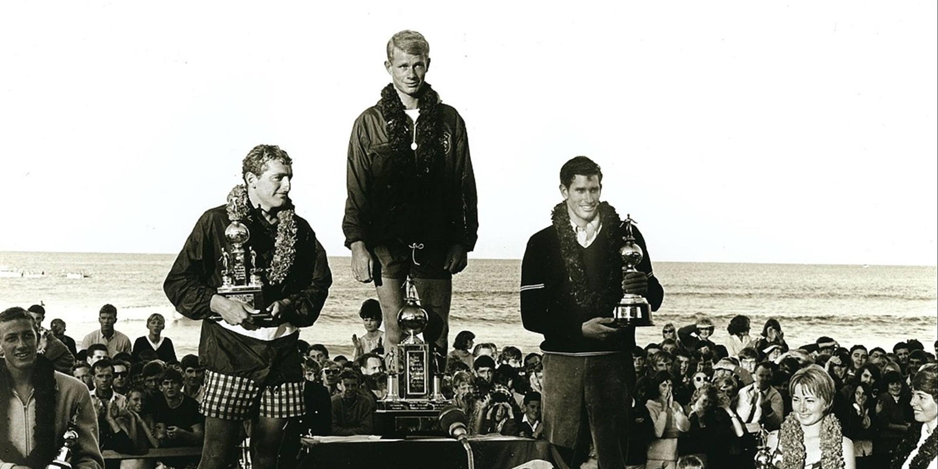 Senior men’s championship winners on the podium: 1 Midget Farrelly, Australia (centre), 2 Mike Doyle, California (left), 3 Joey Cabell, Hawaii (right). 